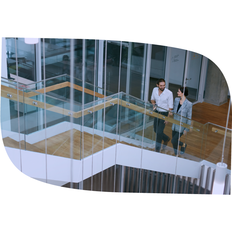 Man and woman walk up stairs together while talking